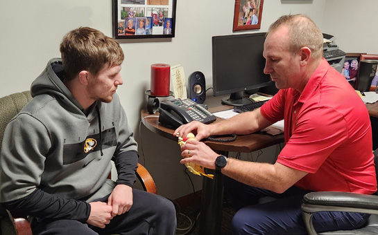 Chiropractor Columbia MO Brooks Travis With Patient And Spine